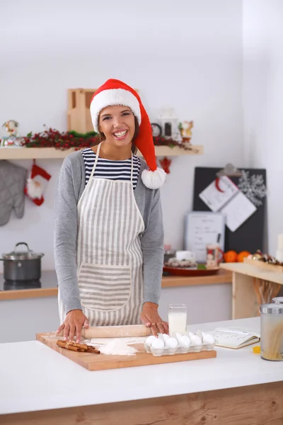 Happy young woman smiling happy having fun with Christmas preparations wearing Santa hat — Stock Photo, Image