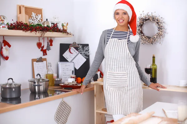 Happy young woman smiling happy having fun with Christmas preparations wearing Santa hat — Stock Photo, Image