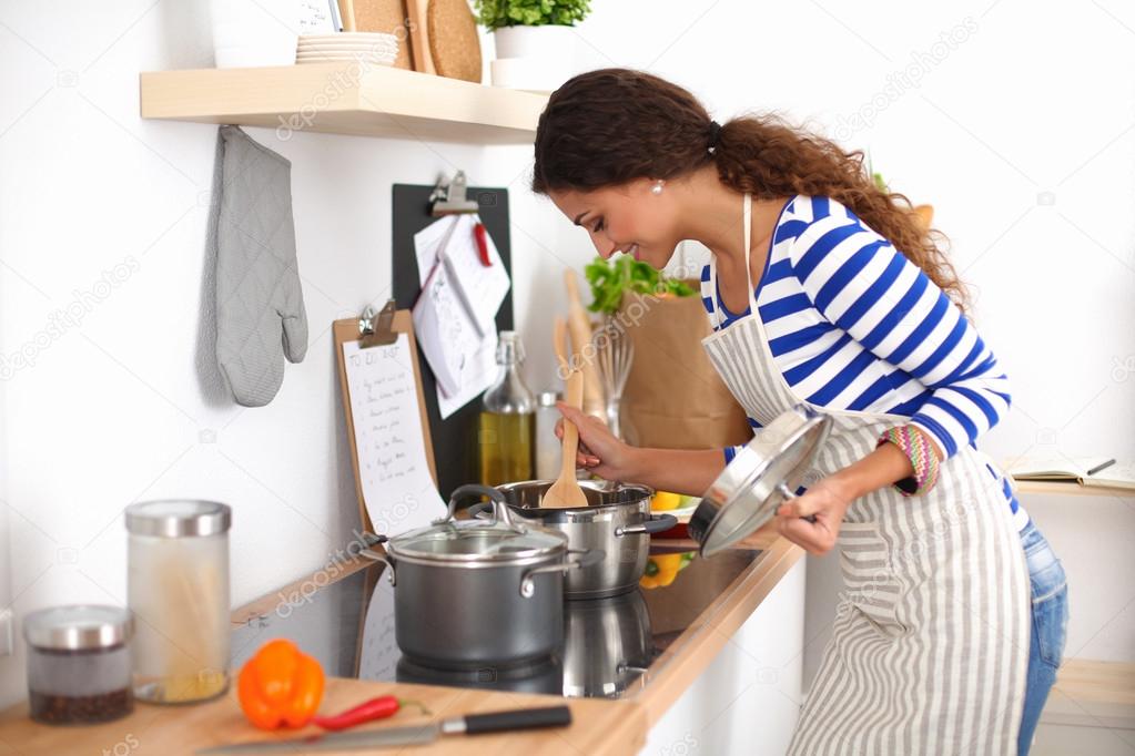 Young woman in the kitchen preparing a food