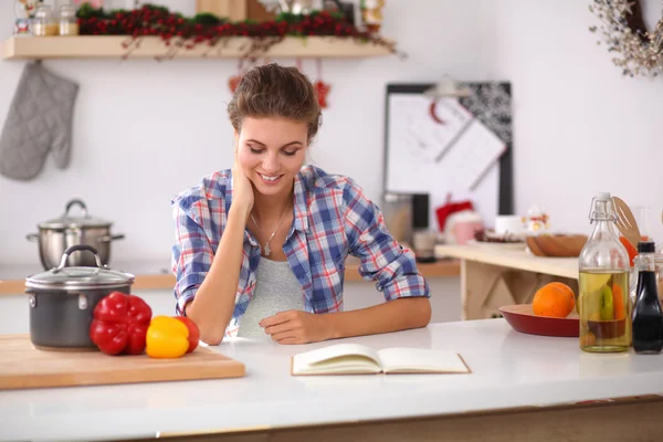Sorrindo jovem na cozinha, isolado no fundo de Natal — Fotografia de Stock