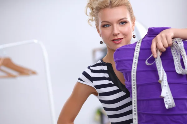 Smiling fashion designer standing near mannequin in office — Stock Photo, Image