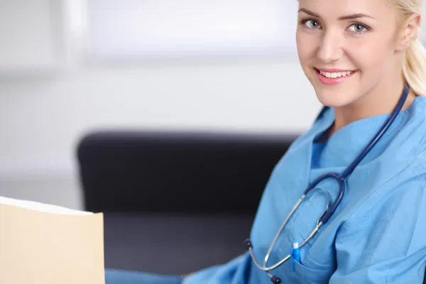 Portret van een gelukkige jonge dokter zittend op de Bank met folde — Stockfoto