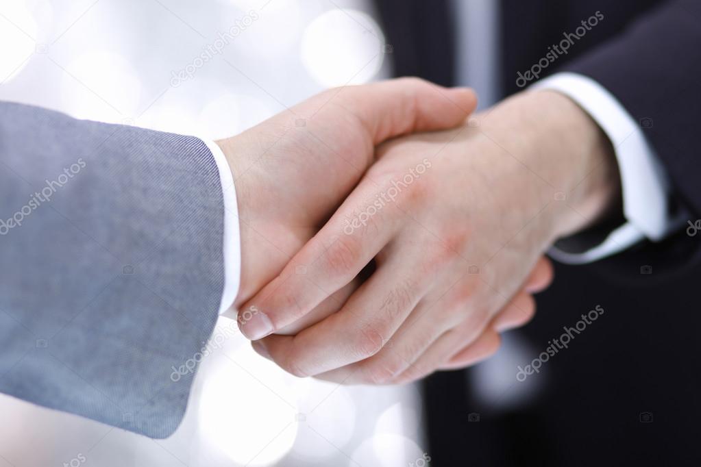 Businessmen shaking hands, isolated on white.