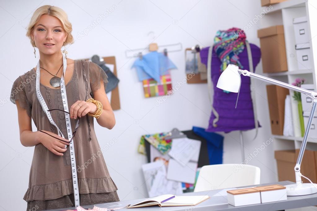 Modern young fashion designer working at studio.