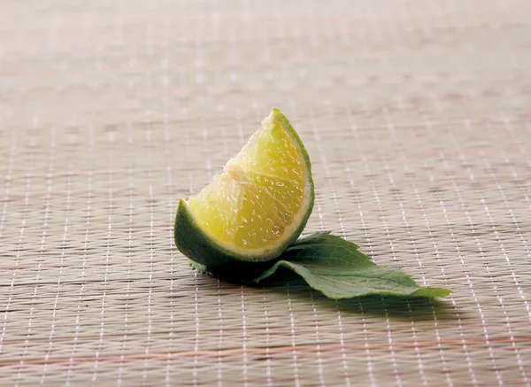 Lime with leaf lying on the desk — Stock Photo, Image