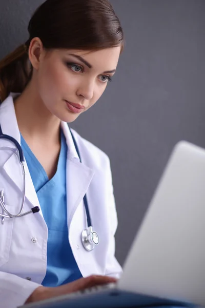 Female doctor working isolated on grey  background — Stock Photo, Image