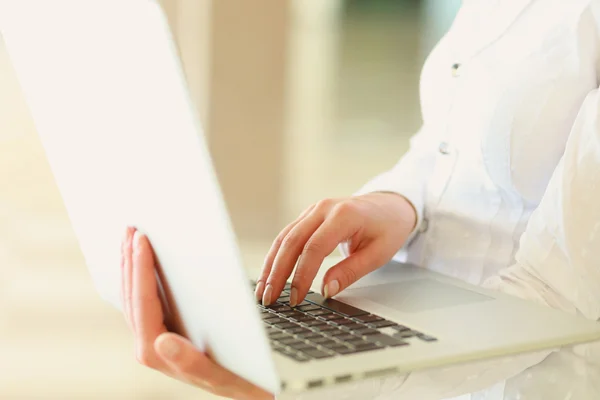 Businesswoman sitting with laptop computer — Stock Photo, Image