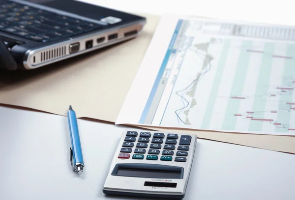 Calculator, pen,laptop, document lying on the desk — Stock Photo, Image