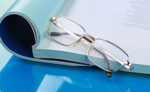 Glasses lying on a book — Stock Photo, Image