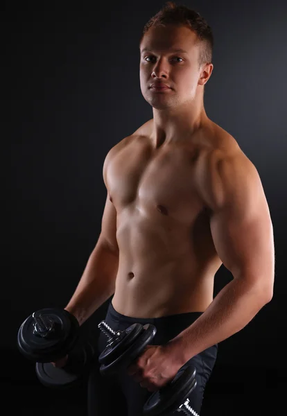 Fit muscular man exercising with dumbbell — Stock Photo, Image