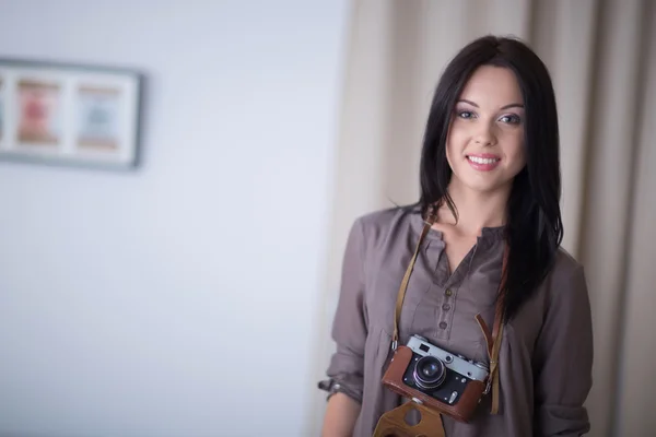 Woman is a proffessional photographer with camera in office — Stock Photo, Image