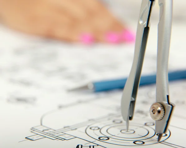 Female architect working with blueprints at office desk — Stock Photo, Image