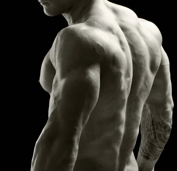 Здоровый мускулистый молодой человек. Изолированный на черном фоне . — стоковое фото