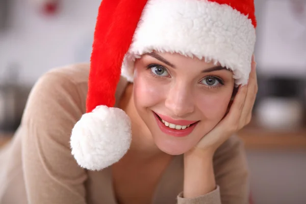 Sorridente giovane donna in cucina, isolata su sfondo natalizio — Foto Stock