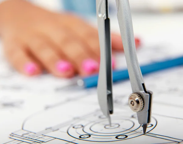 Female architect working with blueprints at office desk — Stock Photo, Image