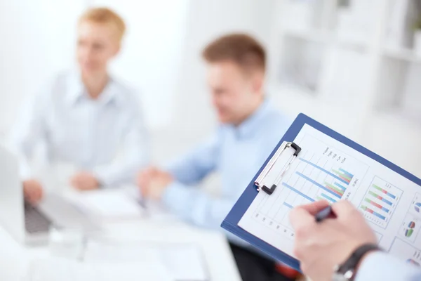 Close-up of businessman explaining a financial plan to colleagues at meeting — Stock Photo, Image