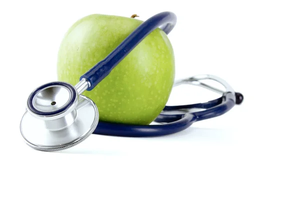 Stetoskop och grönt äpple isolerad på vit bakgrund Stockfoto