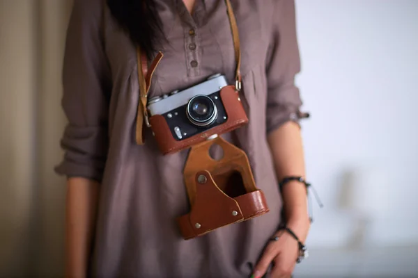 Young woman watching footage on film, standing near window — Stock Photo, Image