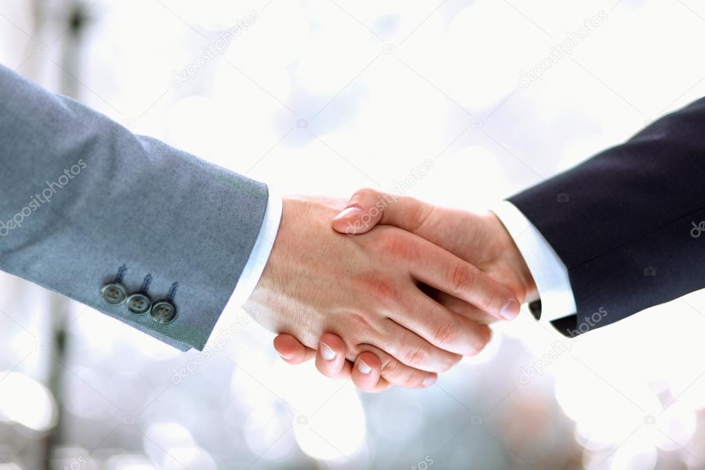 Businessmen shaking hands, isolated on white.