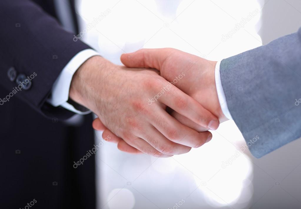 Businessmen shaking hands, isolated on white.