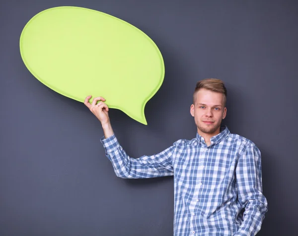 Man holding white blank speech bubble with space for text, isolated — Stock Photo, Image