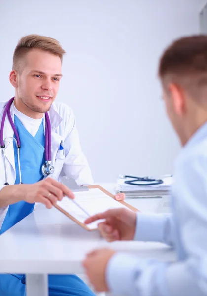 Doctor male giving patient folder with  paper in her office, isolated — Stock Photo, Image