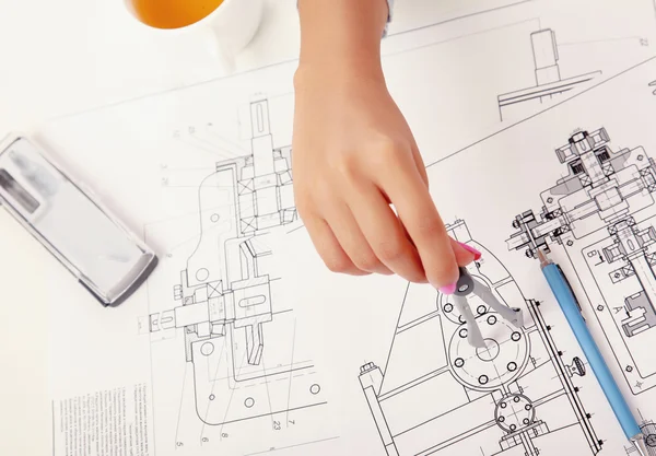 Female architect working with blueprints at office desk — Stock Photo, Image