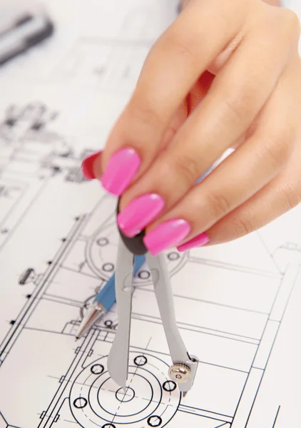 Female architect working with blueprints at office desk — Stock Photo, Image