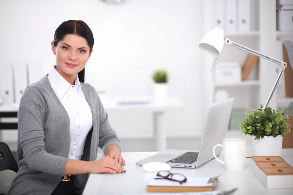 Porträtt av en affärskvinna som sitter vid skrivbordet med laptop — Stockfoto