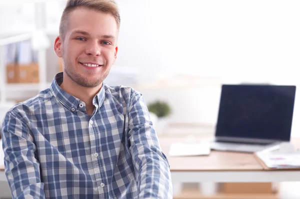 Smiling businessman with red folder sitting in the office — Stock Photo, Image