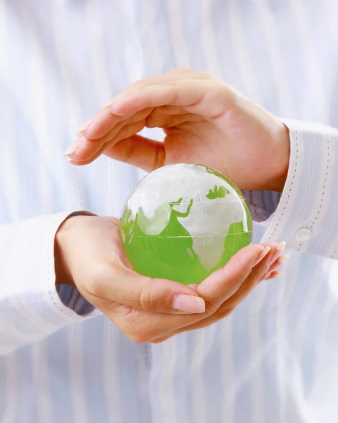 Hands holding a green earth, isolated on white background — Stock Photo, Image