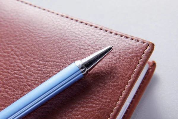 Brown red leather notebook with pen — Stock Photo, Image