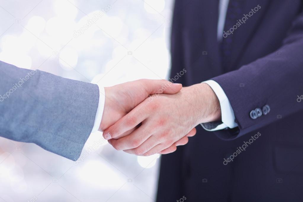 Businessmen shaking hands, isolated on white.