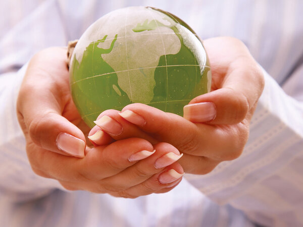 Hands holding a green earth