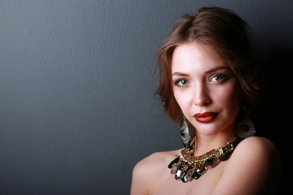 Portrait of young beautiful woman with jewelry — Stock Photo, Image