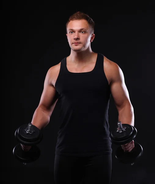 Handsome muscular man working out with dumbbells — Stock Photo, Image