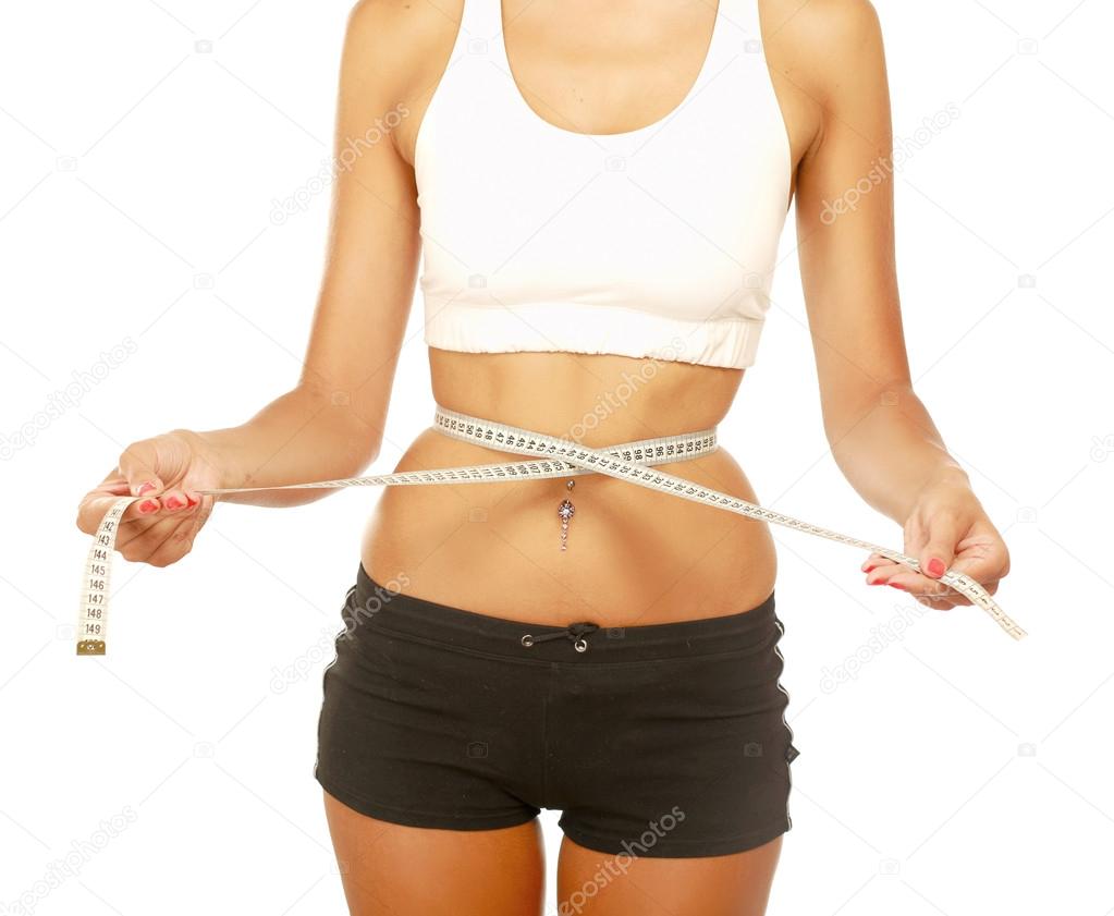 A young woman measuring her waist isolated on white background