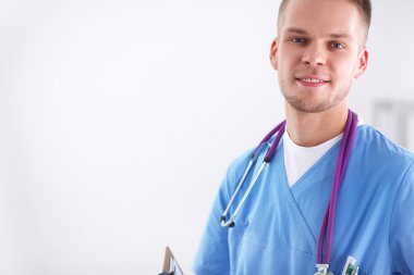 Steteskoplu doktor ayakta, çapraz kollu, beyaz arka planda izole.