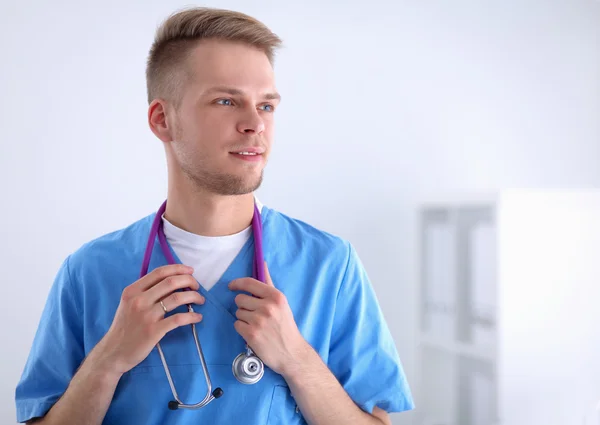 Doctor with stethoscope standing , crossed arms, isolated on white background — Stock Photo, Image