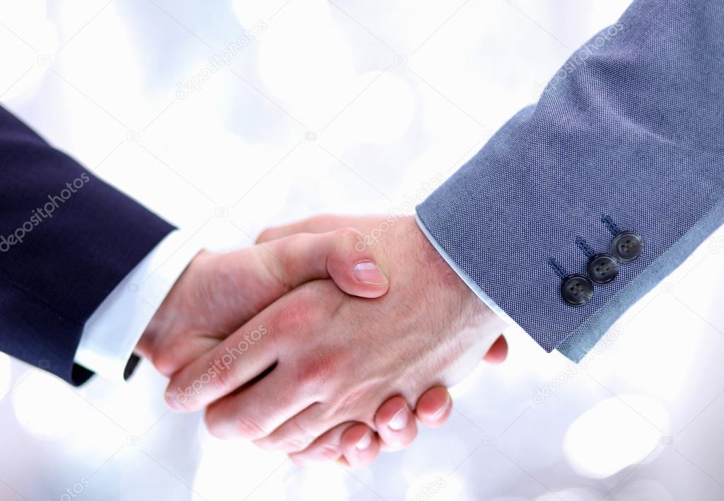 Businessmen shaking hands, isolated on white.