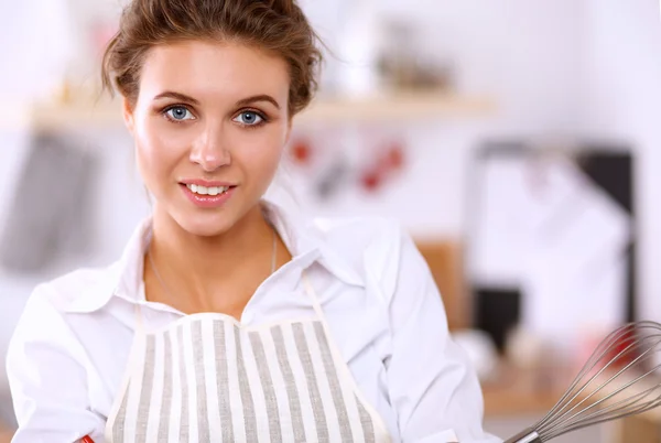 Woman with corolla standing in the kitchen — Stock Photo, Image