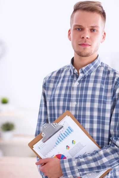 Smiling businessman with folder sitting in the office — Stock Photo, Image