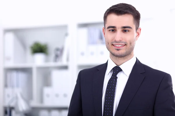 Portrait of young man standing in office — Stock Photo, Image