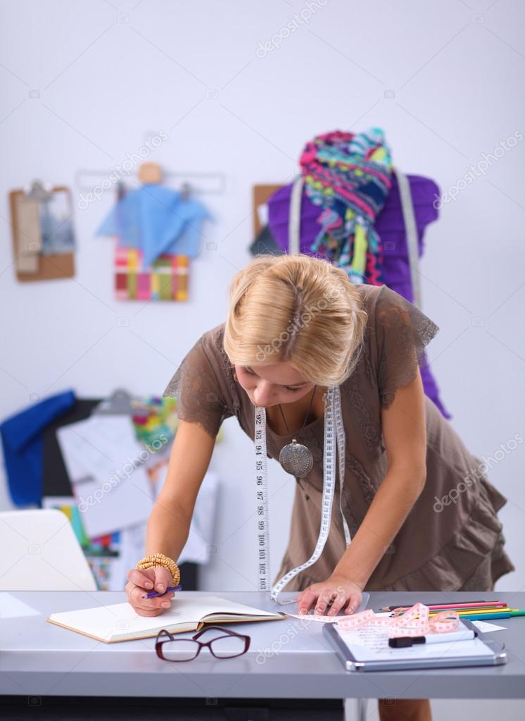 Young fashion designer working at studio.