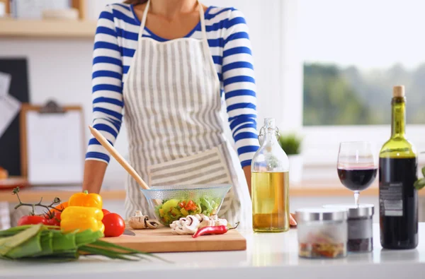 Jeune femme mélangeant salade fraîche — Photo