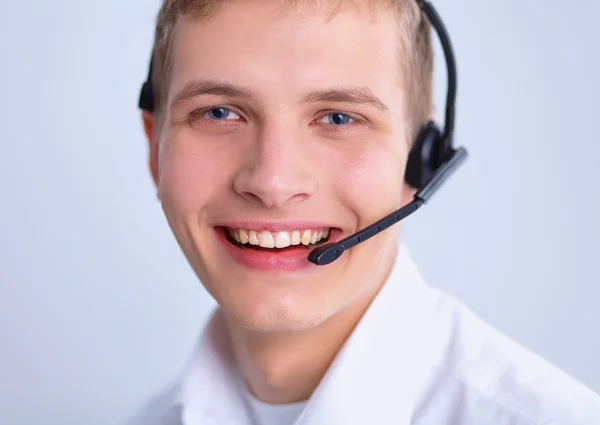 Υποστήριξης πελατών χειριστή με ένα ακουστικό σε άσπρο φόντο — Φωτογραφία Αρχείου