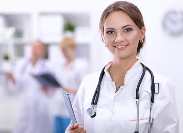 Portrait of woman doctor at hospital with folder — Stock Photo, Image