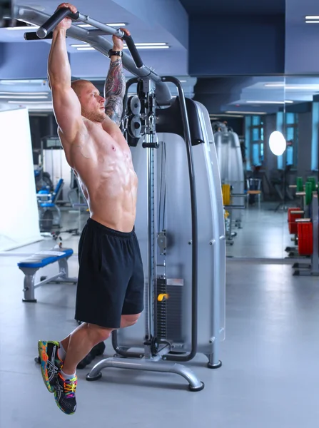 Young man training at gym with exercises — Stock Photo, Image