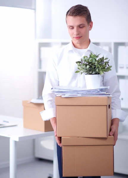 Portrait of a person with moving box and other stuff isolated on white — Stock Photo, Image