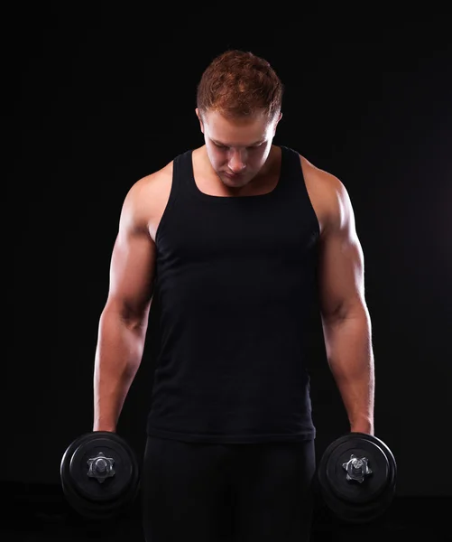 Handsome muscular man working out with dumbbells Stock Picture